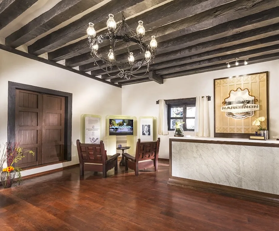 Empty reception room with desk, chairs and timber beams