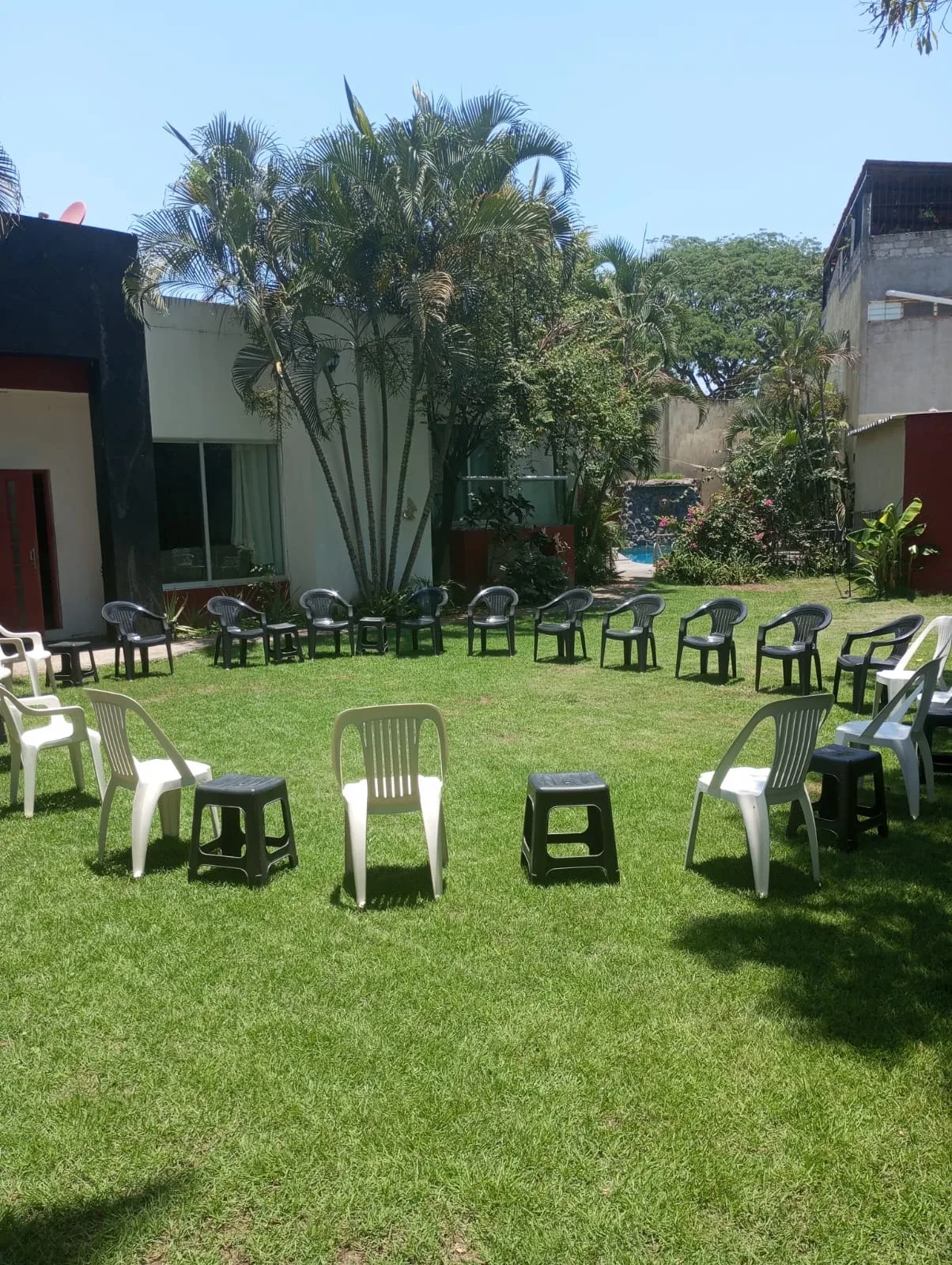 Chairs arranged on the lawn outside the residence