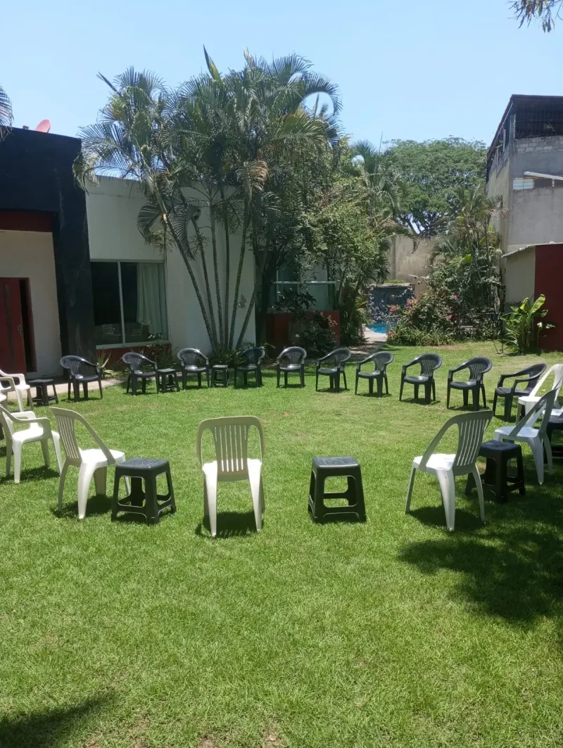 Chairs arranged on the lawn outside the residence
