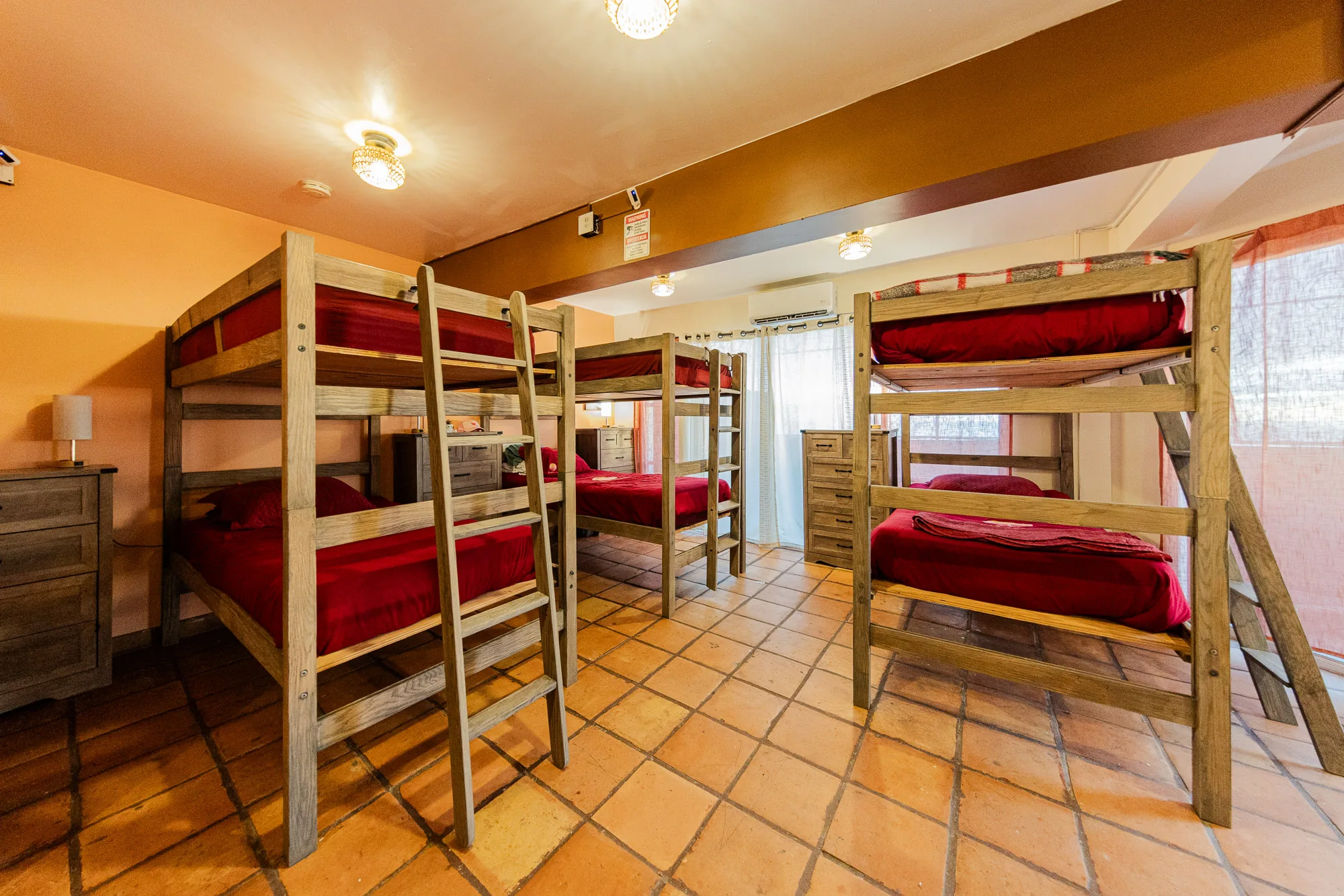 Shared Baja Rehab bedroom with wooden bunk beds and storage drawers