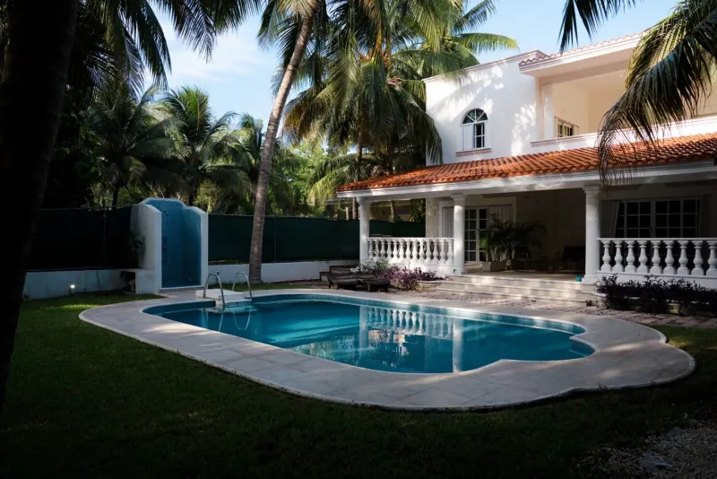 Pool and residential exterior at Ibogaine Clinic.