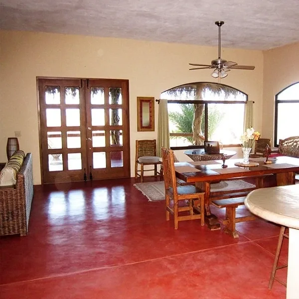 Empty dining area with wooden table and chairs