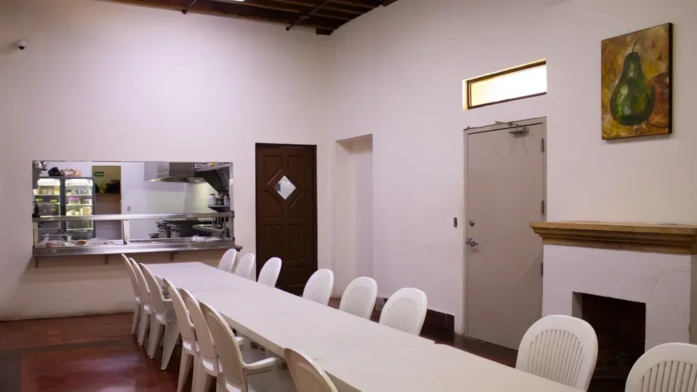 Dining room with a long table and white chairs