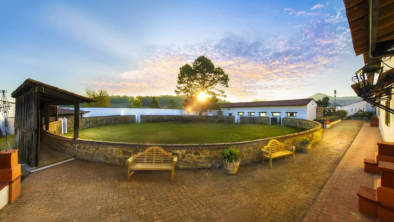 Historic bullring and hacienda grounds at sunset