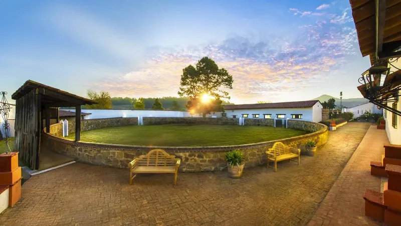 Historic bullring and hacienda grounds at sunset