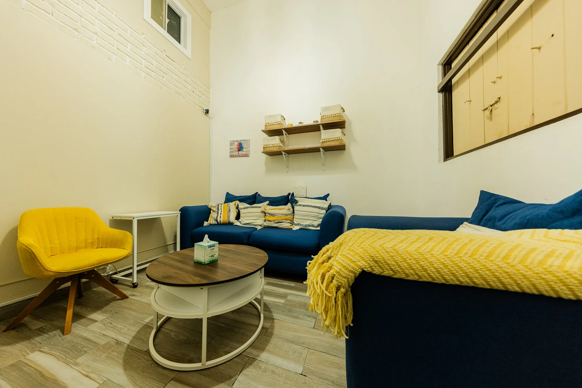 Shared seating room at Baja Rehab with blue sofas and a round coffee table