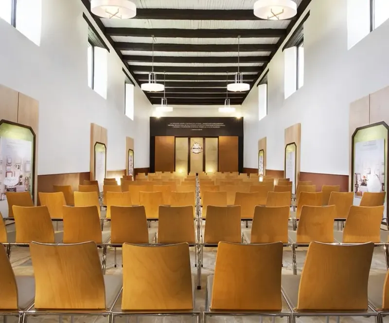 Auditorium with rows of wooden chairs