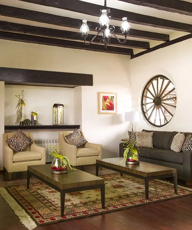 Shared living room with armchairs and side tables