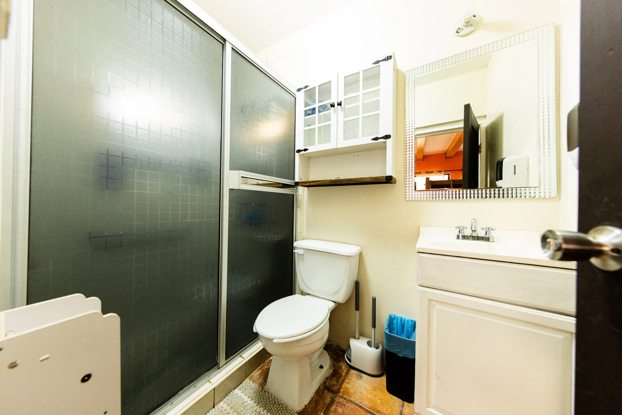 Baja Rehab bathroom with a glass shower enclosure and wall-mounted cabinets