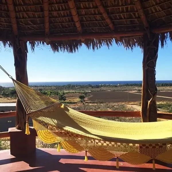 Hammock under a shaded palapa balcony with ocean views