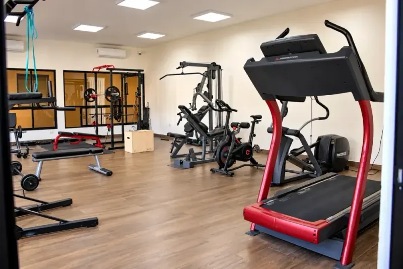 Gym with a treadmill, an exercise bike and weight machines