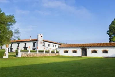 Hacienda exterior and broad green lawn