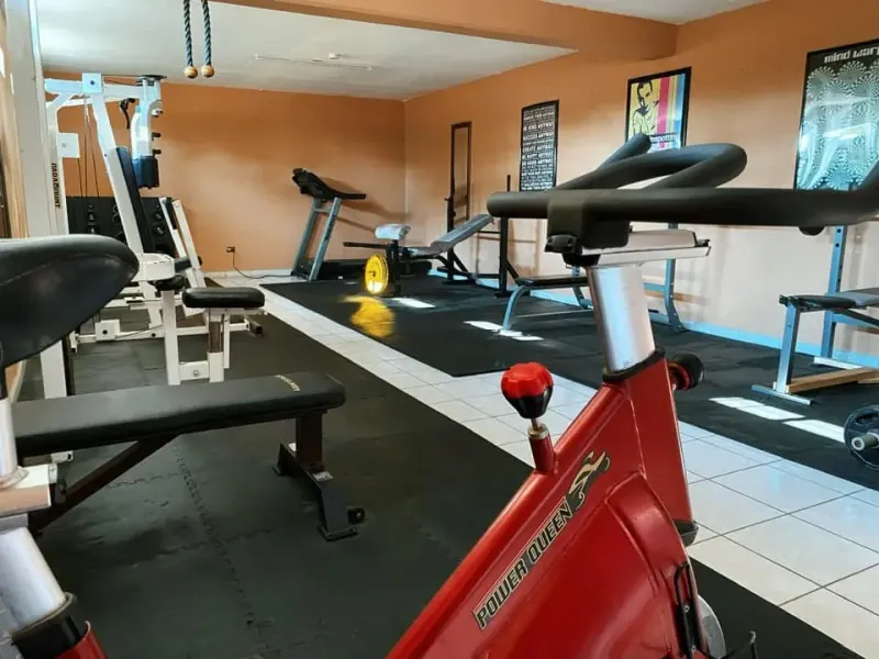 Empty onsite gym with exercise bikes, treadmills and fitness equipment