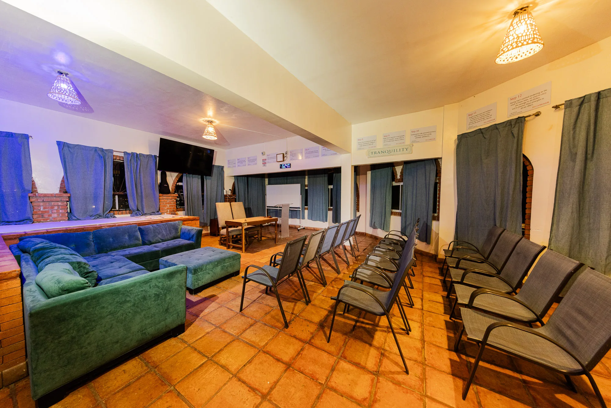 Baja Rehab meeting room with rows of chairs and blue seating