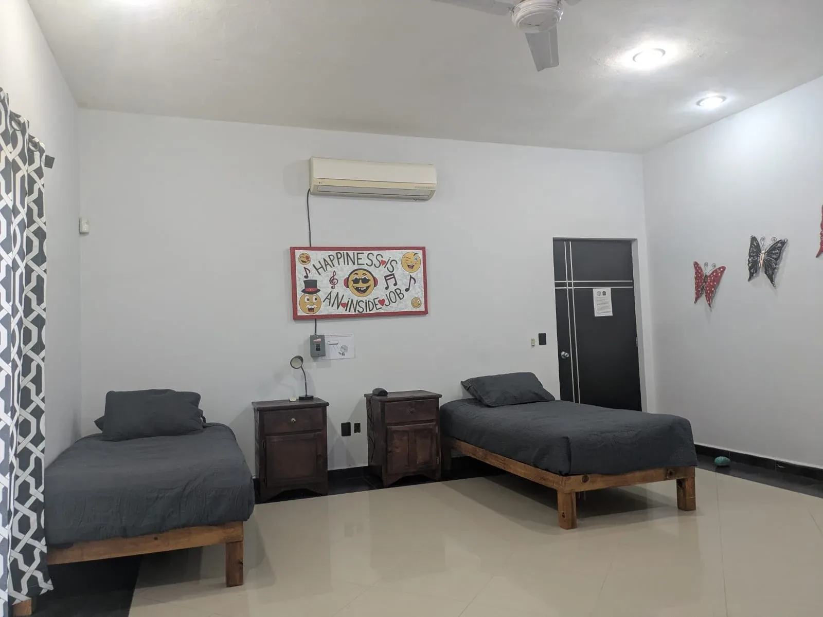 Bedroom with two single beds, bedside tables and air conditioning