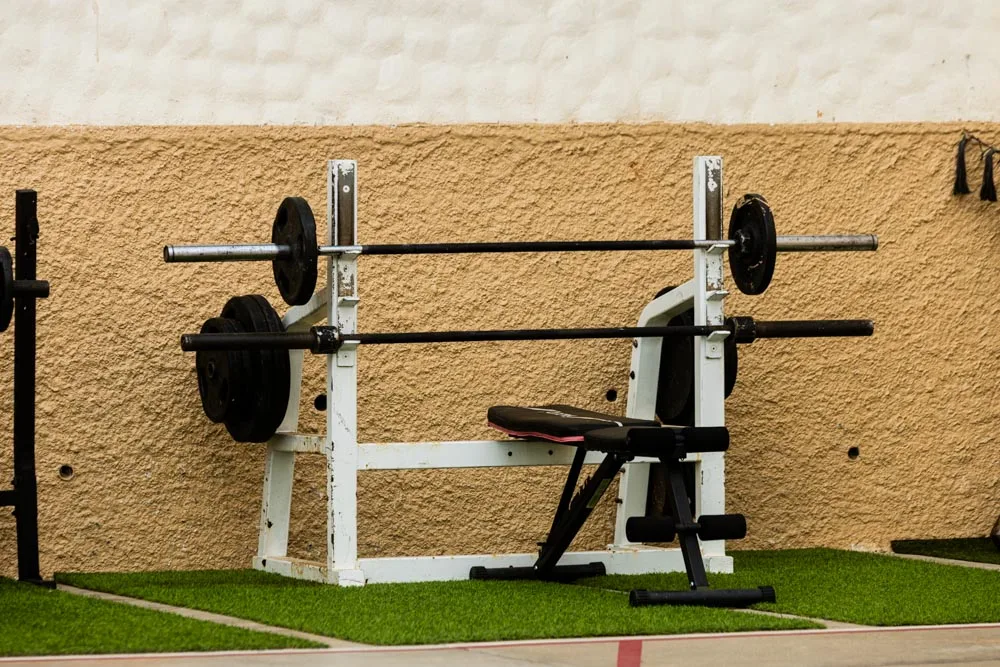 Outdoor weight bench and barbell equipment at Baja Rehab